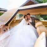 Bride and groom in vintage car interior