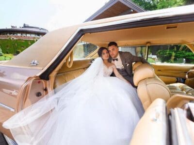 Bride and groom in vintage car interior