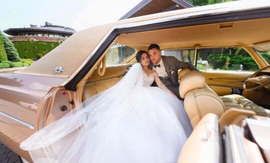 Bride and groom in vintage car interior