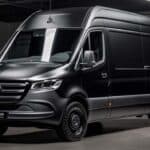 Black Mercedes-Benz cargo van in garage