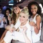 Friends celebrating with champagne in limousine