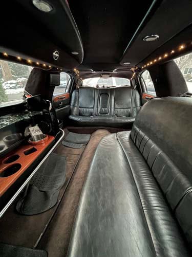 Luxury limousine interior with leather seats and bar