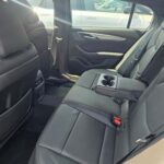 Black leather rear car seats with fold-down armrest