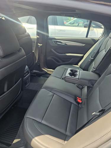 Black leather rear car seats with fold-down armrest