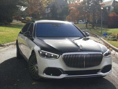 Two tone luxury sedan parked on suburban street