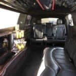 Luxury limousine interior with leather seats and minibar