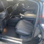 Luxury car rear interior with leather seats and screens