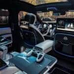 Luxury car interior with gaming setup and panoramic roof