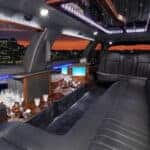 Luxury limousine interior with bar and city skyline