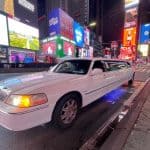 White stretch limousine in Times Square at night