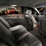 Luxury car interior with leather seats and city lights