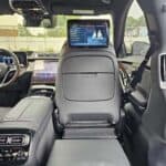 Luxury SUV interior with folded rear seat and screen