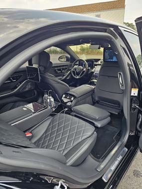 Luxury car interior with black quilted leather seats