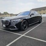 Black Mercedes-Benz sedan parked in empty lot