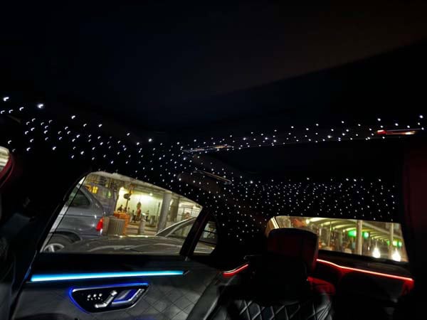 Luxury car interior with starry ceiling lights