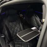 Luxury car rear seats with quilted leather and tray table