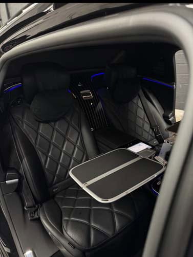 Luxury car rear seats with quilted leather and tray table