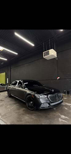 Black luxury sedan in dimly lit garage