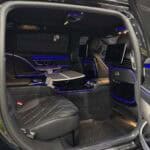 Luxury van interior with blue ambient lighting and leather seats