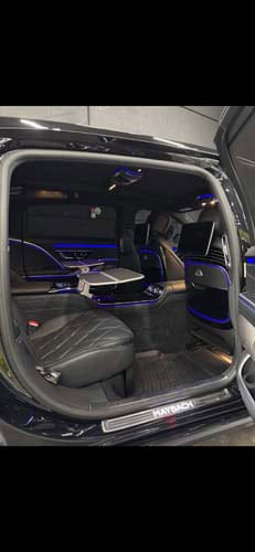 Luxury van interior with blue ambient lighting and leather seats