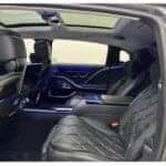 Luxury car interior with black leather and blue lighting