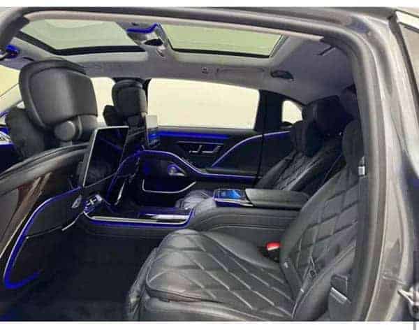 Luxury car interior with black leather and blue lighting