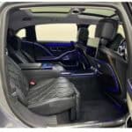 Luxury car rear seats with blue ambient lighting