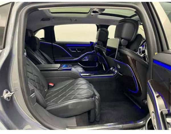 Luxury car rear seats with blue ambient lighting