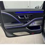 Car door interior with blue ambient lighting