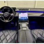 Mercedes-Benz luxury interior with touchscreen and blue ambient lighting