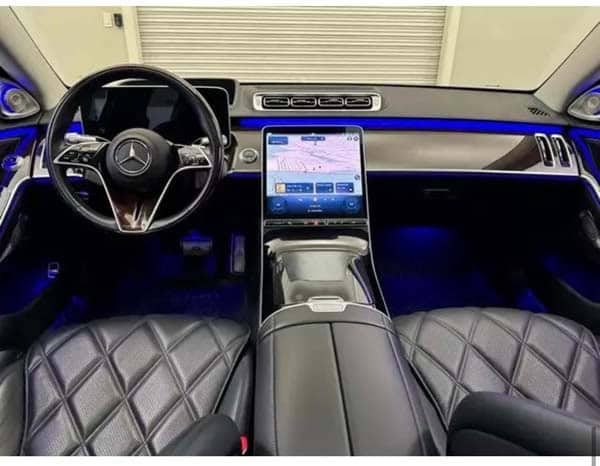 Mercedes-Benz luxury interior with touchscreen and blue ambient lighting