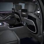 Luxury car rear seats with screens and ambient lighting