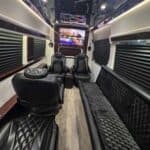 Luxury van interior with leather seats and TV
