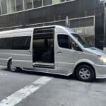 Silver passenger van with sliding door open on street