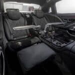 Luxury car rear seats with tray tables and glasses