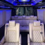 Luxury van interior with cream leather seats and blue lighting