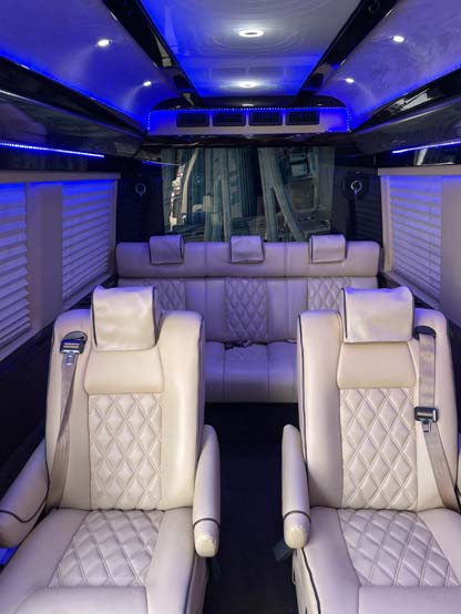 Luxury van interior with cream leather seats and blue lighting