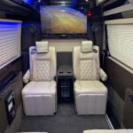 Luxury van interior with cream leather seats and blue lighting