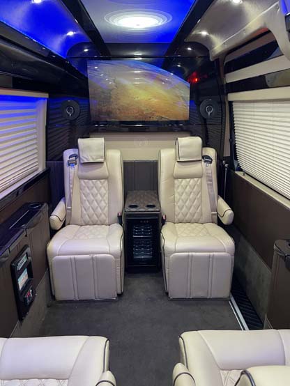 Luxury van interior with cream leather seats and blue lighting