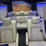 Luxury van interior with cream leather seats and blue lighting