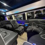 Luxury party bus interior with quilted leather and starry ceiling.
