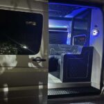 Luxury van interior featuring blue LED lighting and plush seating.