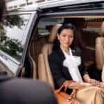 Well-dressed woman sitting in luxury SUV backseat
