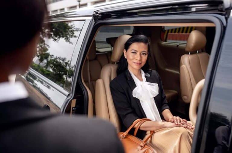 Well-dressed woman sitting in luxury SUV backseat