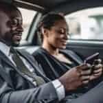 Two professionals using smartphones in car backseat