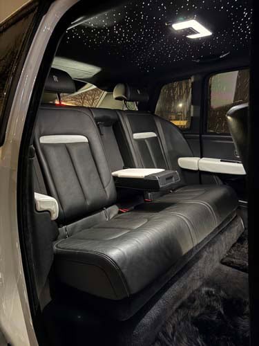 Luxury car rear seats with starry ceiling lights
