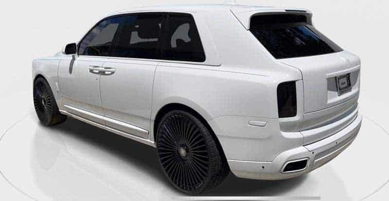 White luxury SUV with black wheels rear view