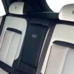 Luxury car rear seats with white leather upholstery