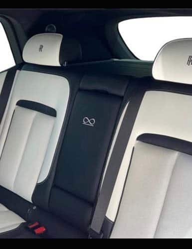 Luxury car rear seats with white leather upholstery