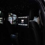 Luxury car interior with rear screens and starlit ceiling